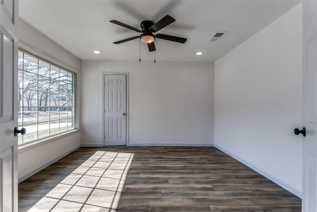 spare room with dark hardwood / wood-style floors and ceiling fan