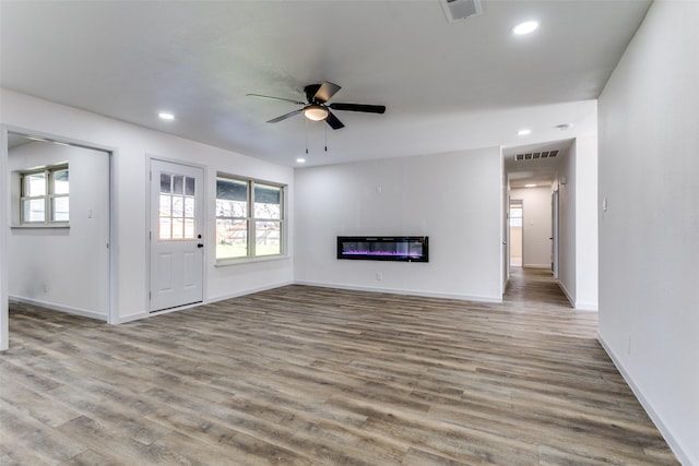 unfurnished living room featuring ceiling fan and light hardwood / wood-style floors