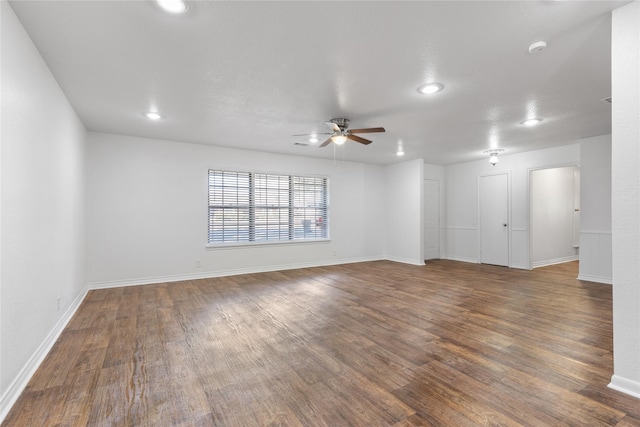 unfurnished room with dark hardwood / wood-style floors and ceiling fan