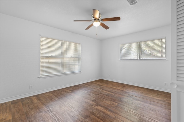 spare room featuring ceiling fan and dark hardwood / wood-style floors