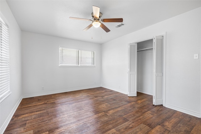 unfurnished bedroom featuring ceiling fan, dark hardwood / wood-style flooring, and a closet