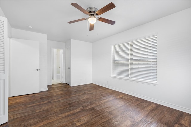 unfurnished bedroom with ceiling fan and dark hardwood / wood-style flooring