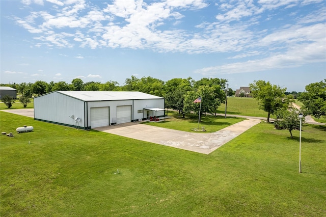 view of yard with a garage and an outdoor structure