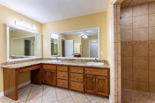 bathroom with tile patterned flooring, vanity, tiled shower, and ceiling fan