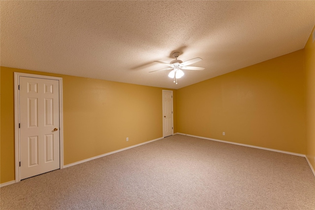 carpeted empty room featuring a textured ceiling and ceiling fan