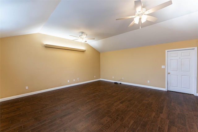 spare room with dark hardwood / wood-style flooring, vaulted ceiling, and ceiling fan