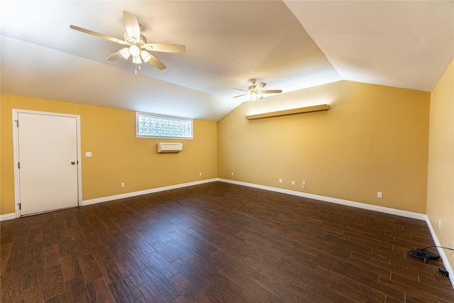 additional living space with dark hardwood / wood-style flooring, ceiling fan, vaulted ceiling, and a wall mounted AC