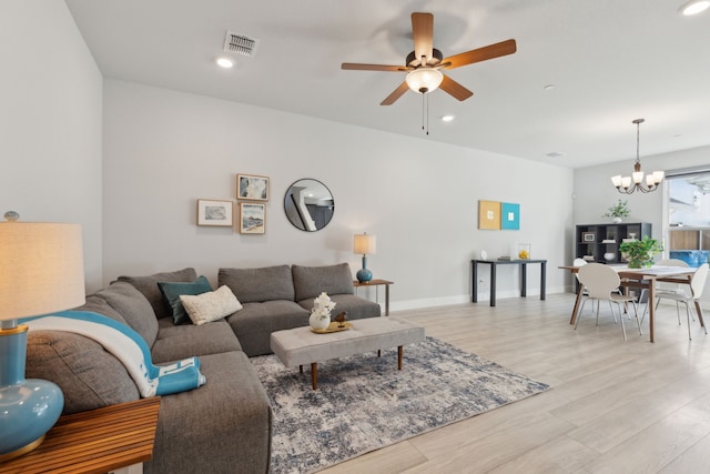 living room featuring light wood-type flooring, visible vents, baseboards, and recessed lighting