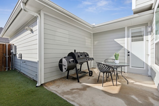 view of patio featuring fence, grilling area, and outdoor dining space