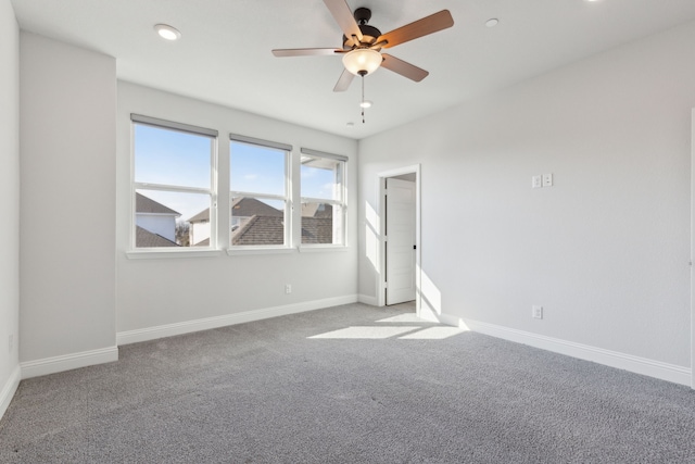 spare room featuring a ceiling fan, recessed lighting, light carpet, and baseboards