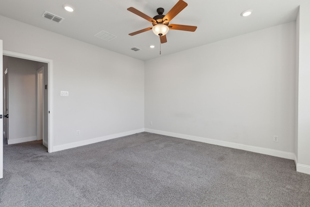 empty room with carpet floors, baseboards, visible vents, and recessed lighting