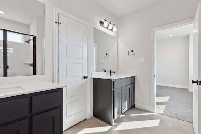 full bath featuring tile patterned flooring, recessed lighting, vanity, baseboards, and a stall shower