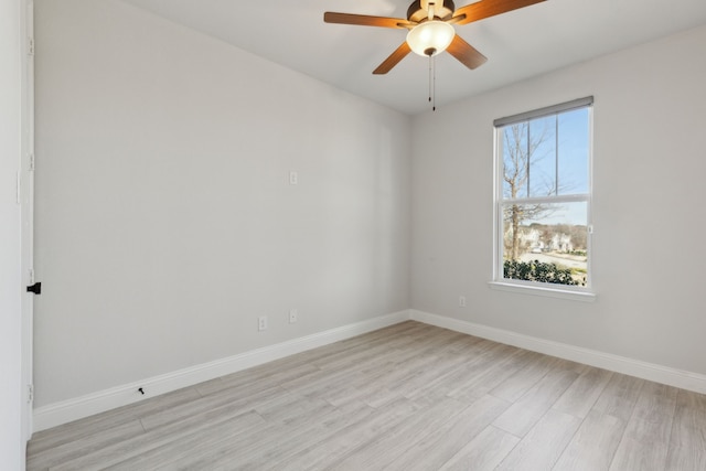 unfurnished room with a ceiling fan, baseboards, and light wood finished floors