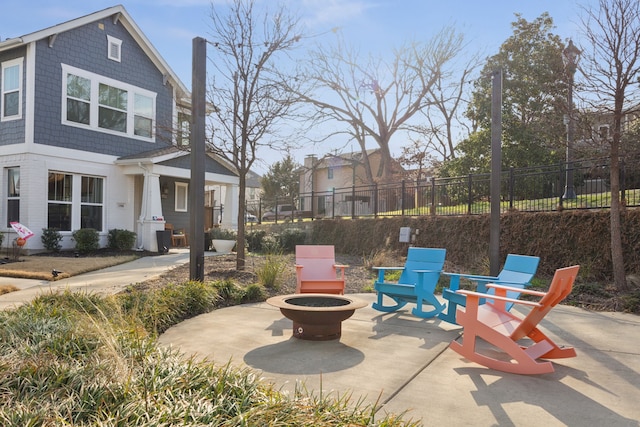 view of patio / terrace featuring a fire pit and fence