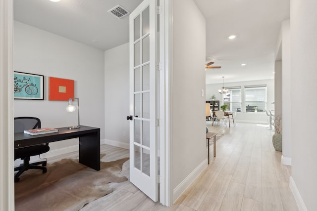 office featuring light wood finished floors, recessed lighting, visible vents, a chandelier, and baseboards