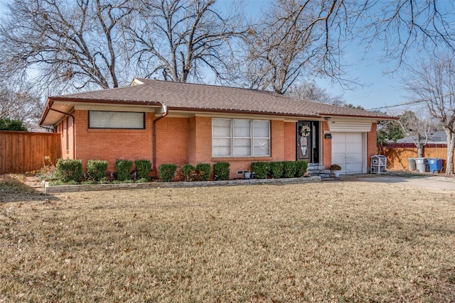 single story home with a garage and a front lawn