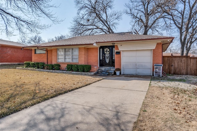 ranch-style home with a garage and a front lawn