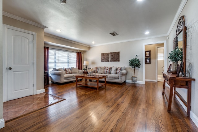 living area featuring visible vents, baseboards, dark wood-style floors, and ornamental molding