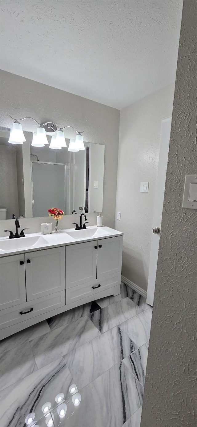 bathroom featuring vanity and a textured ceiling