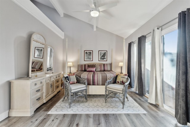 bedroom featuring ceiling fan, light hardwood / wood-style floors, and vaulted ceiling with beams