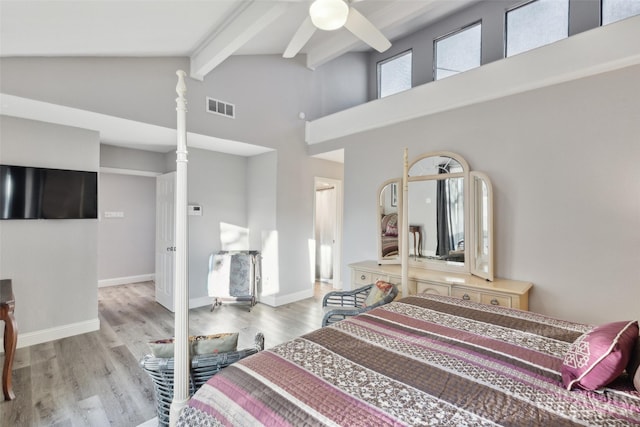 bedroom featuring beam ceiling, high vaulted ceiling, and light hardwood / wood-style flooring