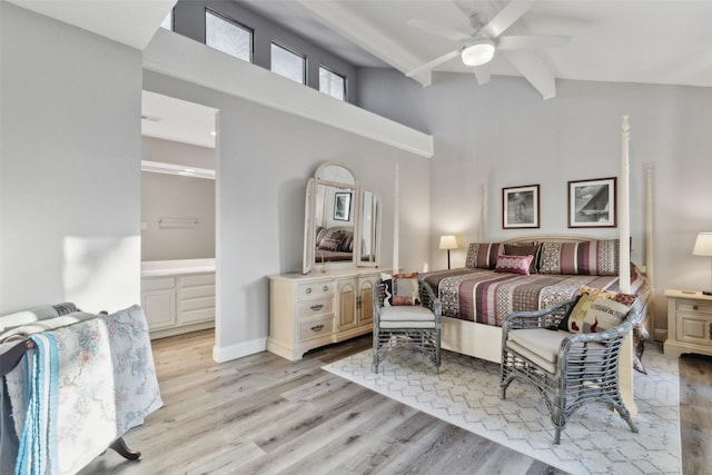 bedroom featuring connected bathroom, light hardwood / wood-style flooring, beam ceiling, ceiling fan, and high vaulted ceiling