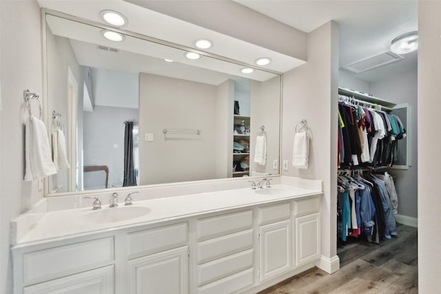 bathroom with vanity and hardwood / wood-style floors