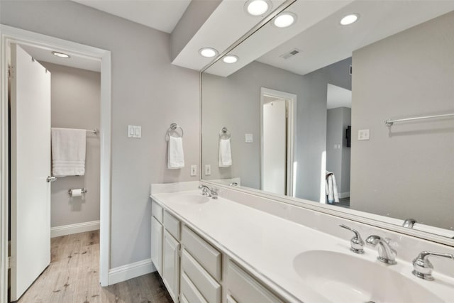 bathroom featuring vanity and hardwood / wood-style flooring