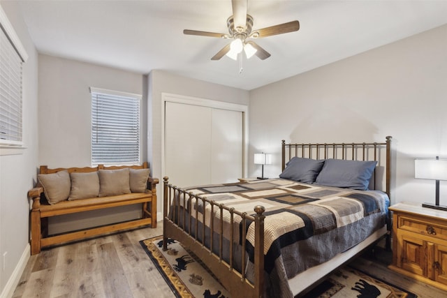 bedroom featuring light wood-type flooring, a closet, and ceiling fan