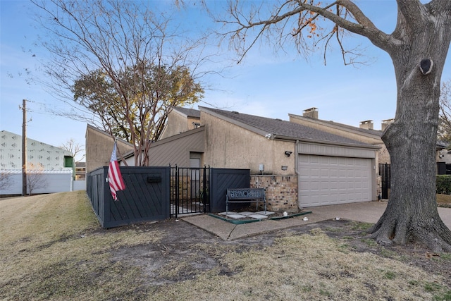 view of property exterior featuring a garage and a lawn