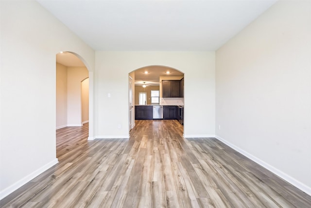 unfurnished living room with ceiling fan and light hardwood / wood-style flooring