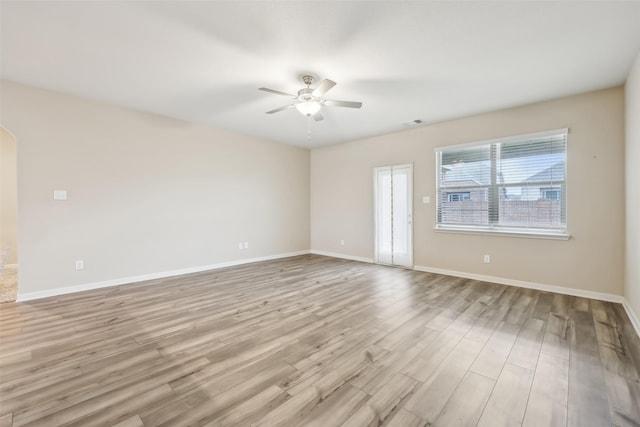 unfurnished room featuring ceiling fan and light wood-type flooring