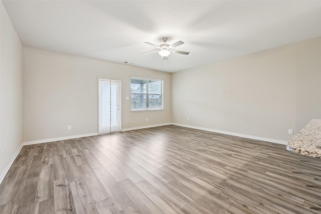 unfurnished room with ceiling fan and light wood-type flooring