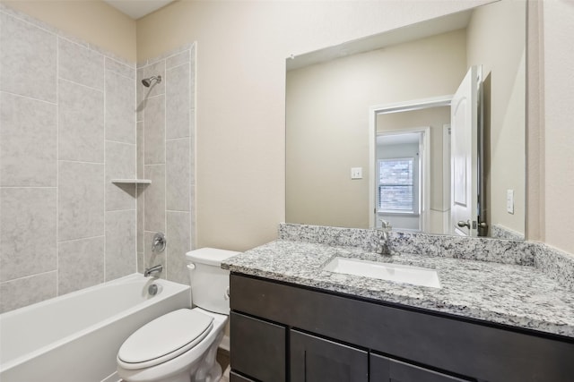 full bathroom featuring vanity, tiled shower / bath combo, and toilet