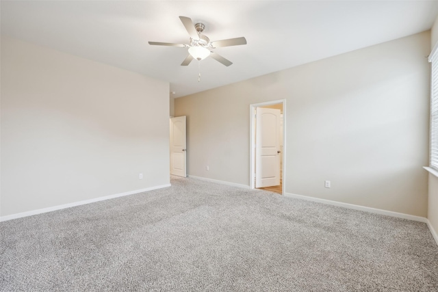 carpeted spare room with ceiling fan