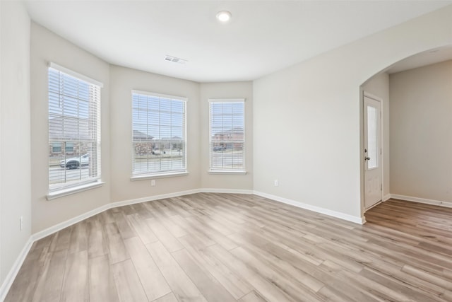 unfurnished room with light hardwood / wood-style floors