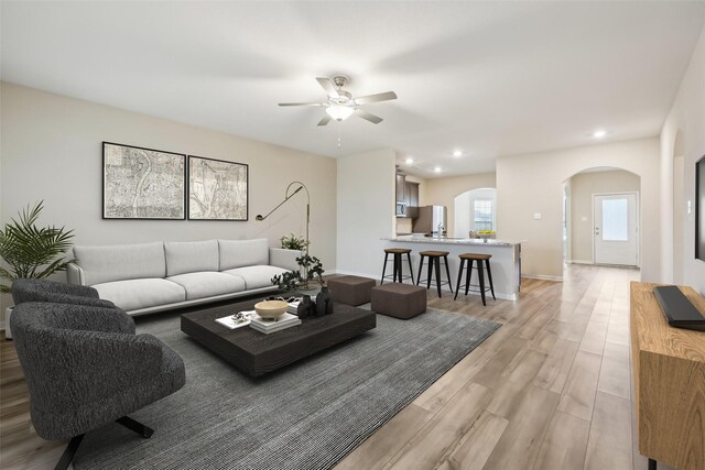 unfurnished living room with ceiling fan and light hardwood / wood-style floors