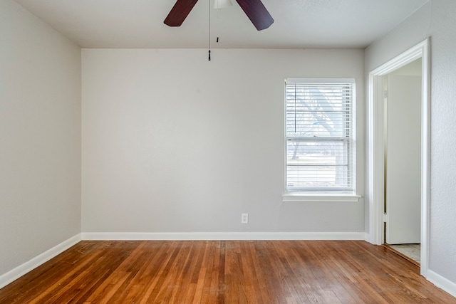 empty room featuring wood-type flooring and ceiling fan