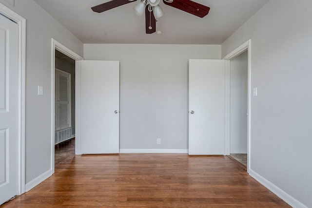 unfurnished bedroom featuring hardwood / wood-style flooring and ceiling fan