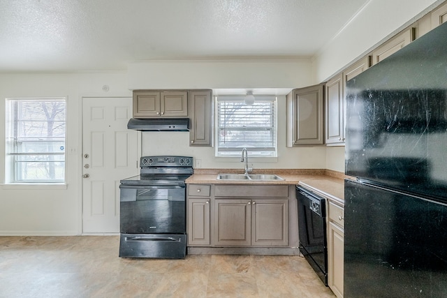 kitchen featuring sink, a textured ceiling, and black appliances