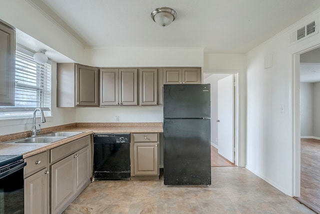 kitchen with ornamental molding, sink, and black appliances