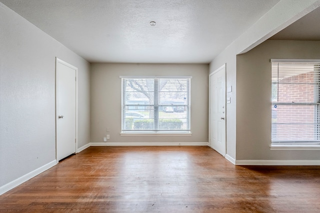 foyer with hardwood / wood-style flooring and a textured ceiling