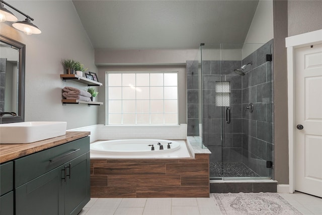 bathroom featuring tile patterned floors, vanity, plus walk in shower, and vaulted ceiling