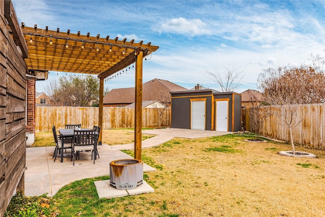 view of yard featuring a shed, a fire pit, a patio area, and a pergola