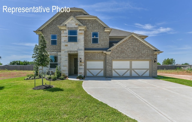 view of front of house featuring a garage and a front lawn