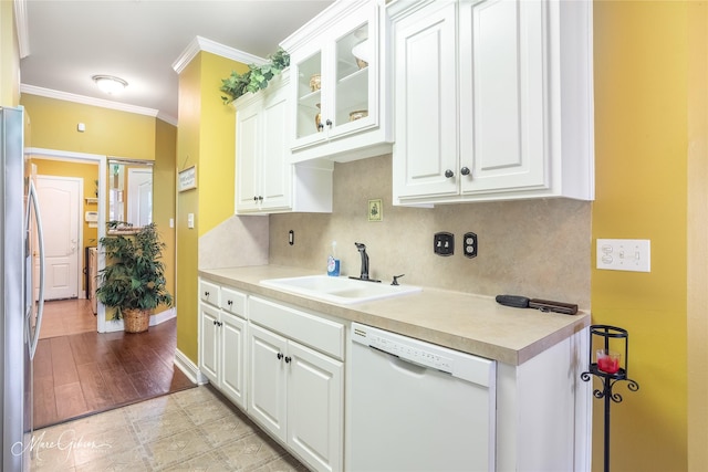 kitchen with white cabinetry, dishwasher, sink, stainless steel fridge, and ornamental molding