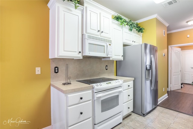 kitchen with backsplash, white appliances, ornamental molding, and white cabinets