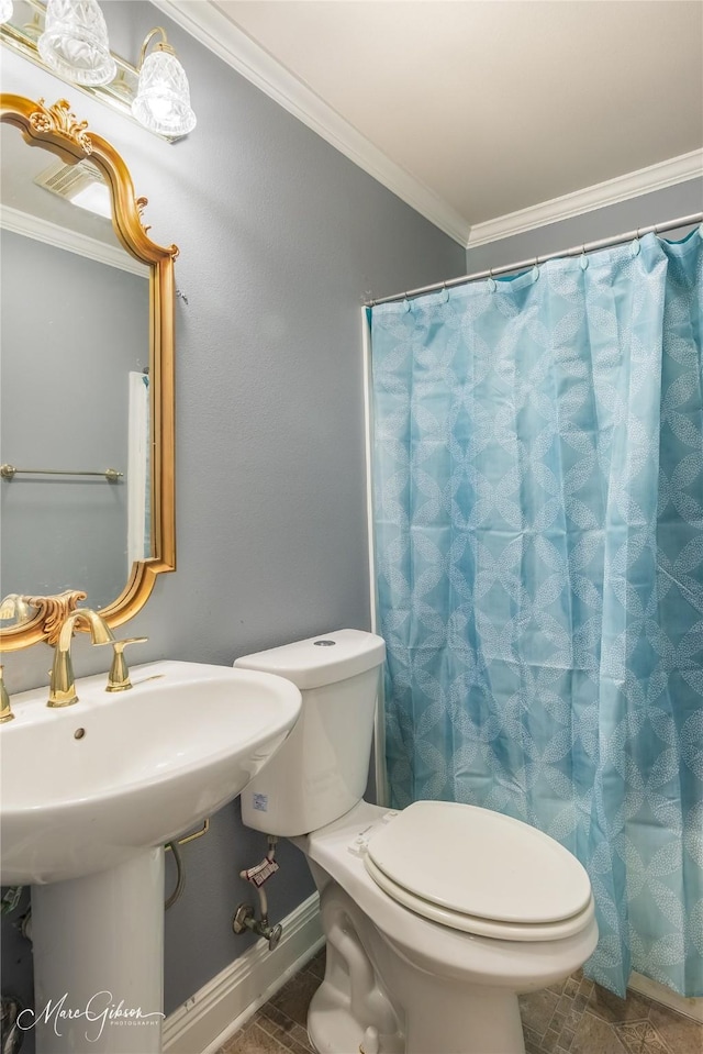 bathroom with ornamental molding and toilet