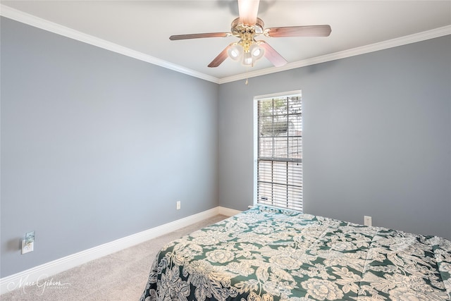 carpeted bedroom with ornamental molding and ceiling fan