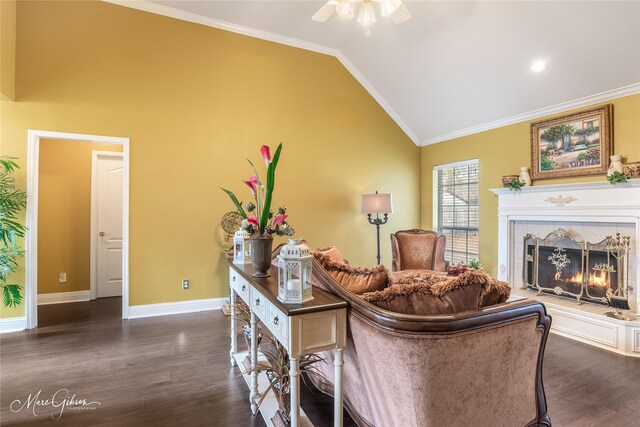 living room featuring a tiled fireplace, high vaulted ceiling, dark wood-type flooring, and ornamental molding